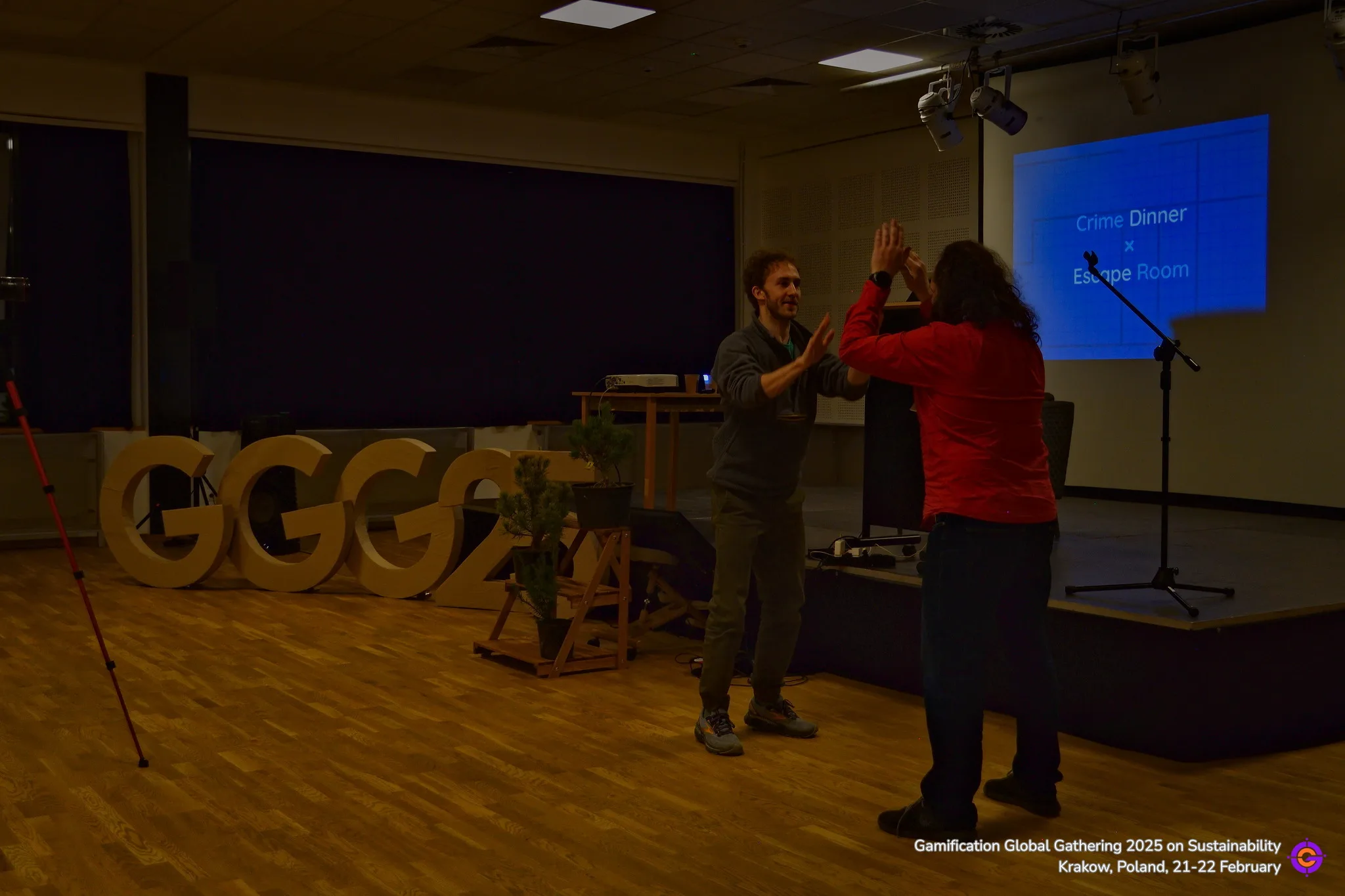 Sure! Here's the alt text:

Gamification Global Gathering event participants high-fiving.