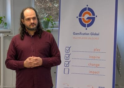 A man standing in front of Gamification Global Rollup