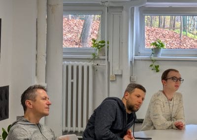 3 guys listening to a talk