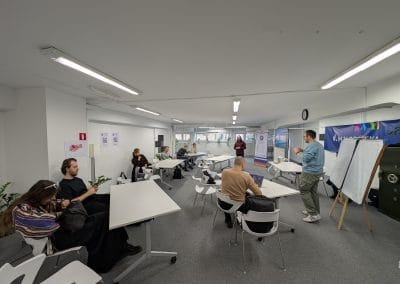 A man presenting in front of a full room of people