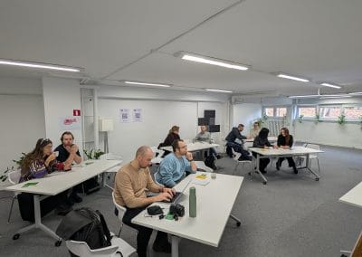 A room full of people listening to a presentation