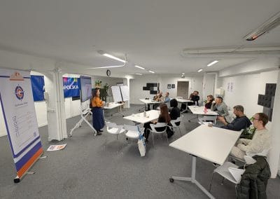 A room full of people listening to a talk